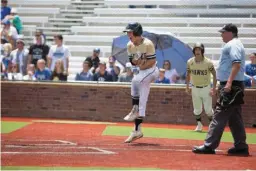  ?? Staff photo by Evan Lewis ?? Pleasant Grove’s Cade Thompson celebrates after scoring the Hawk’s winning run on a single by Heath Ferguson in the eighth inning of Game 2 in Thursday’s regional final against Decatur at Mike Carter Field in Tyler.