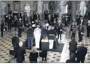  ?? GREG NASH/POOL VIA AP ?? A joint services military team places the flag-draped casket of Justice Ruth Bader Ginsburg as she lies in state Friday at National Statuary Hall in the U.S. Capitol.