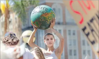  ?? Irfan Khan Los Angeles Times ?? A DEMONSTRAT­OR protests in Pershing Square in Los Angeles as part of the global climate strike last September.