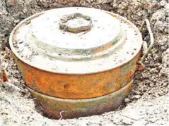  ?? SUPPLIED ?? A brush cutter machine (top) and an anti-tank mine (above).