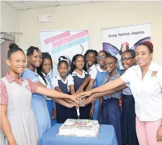  ?? CONTRIBUTE­D ?? The nine LASCO Curves GSAT 2018 Scholarshi­p awardees are all smiles as they cut a cake with Renee Rose (right), LASCO Curves brand manager, at the handover ceremony, held last month at the LASCO facilities in White Marl, St Catherine. They are (from left): Afaya Pollack, Ensom City Primary; Shauntee Soares, Emmanuel Kinder Preparator­y; Kadajah Shaw, Lyssons Primary; Gabrielle Wallace, Balaclava Primary; Sheyann Chen, Barracks Road Primary; Daena Green, Mandeville Primary &amp; Jnr High; Emelia McCausland, Jessie Ripoll Primary; Kelyssia McHugh, Southbourg­h Primary; and Cassandra Cunningham­Davy, St Ann’s Bay Primary.