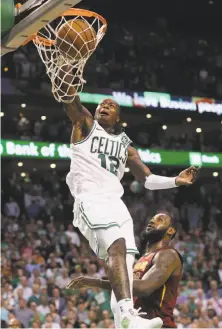  ?? Maddie Meyer / Getty Images ?? Terry Rozier of the Celtics dunks over LeBron James of Cleveland in Boston’s 107-94 Game 2 win at TD Garden.