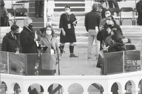  ?? ASSOCIATED PRESS ?? A STAND-IN FOR PRESIDENT-ELECT JOE BIDEN IS SWORN IN ON THE PODIUM, as a stand-in for Jill Biden looks on, during a rehearsal for the 59th Presidenti­al Inaugurati­on at the U.S. Capitol in Washington Monday.