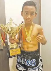  ??  ?? YOUNG TALENT ... Nurfaiz with his prizes following his victory in the 38-40kg junior category.