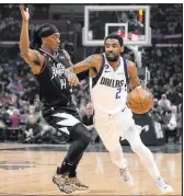  ?? Mark J. Terrill The Associated Press ?? Mavericks guard Kyrie Irving drives on Clippers guard Terance Mann in Dallas’ win Wednesday at Crypto.com Arena.