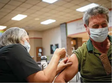  ?? Christophe­r Smith / Washington Post ?? Nurse Susan Hinck gives Richard Thornton the vaccine on July 10 in Springfiel­d, Mo., where hospital wards have been filling up with COVID-19 patients. Cases are rising in areas with low vaccinatio­n rates.