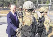  ?? ROBERT BURNS / AP ?? Defense Secretary Jim Mattis greets soldiers Friday at Fort Bragg, N.C. He told soldiers the U.S. military must do its part by being ready for war. Mattis stopped off on a two-day preholiday tour of bases to greet troops.