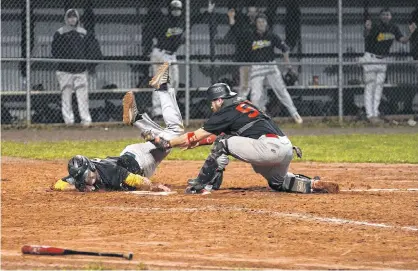  ?? JASON MALLOY/THE GUARDIAN ?? Randy Taylor of The Alley Stratford Athletics dives for the plate while Morell Chevies catcher Desi Doyle attempts to tag him Wednesday during Game 5 of the Kings County Baseball League final in Stratford.