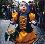  ?? SHMUEL THALER — SANTA CRUZ SENTINEL FILE ?? Santa Cruz’s Mateya Foster is wideeyed with amazement as she trick-ortreats dressed as a monarch butterfly along Pacific Avenue. Festivitie­s won’t be held in Downtown Santa Cruz this Halloween due to the coronaviru­s pandemic.