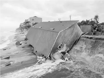  ??  ?? A firefighte­r views a collapsed coastal house after Hurricane Irma passed the area in Vilano Beach, Florida. — Reuters photo