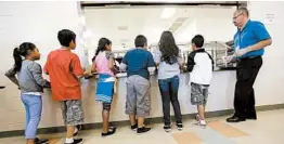  ?? ERIC GAY/AP 2014 ?? Detained immigrant kids line up in the cafeteria at the Karnes County Residentia­l Center in Texas. The administra­tion stopped using the center to hold migrant families in March.