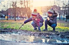  ??  ?? Wet play: more schools are now taking children offline and outside to learn