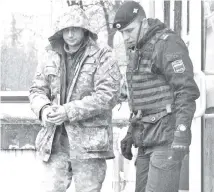  ??  ?? A crew member (left) of one of Ukrainian naval ships, which were recently seized by Russia’s FSB security service, is escorted after a court hearing in Simferopol, Crimea. — Reuters photo