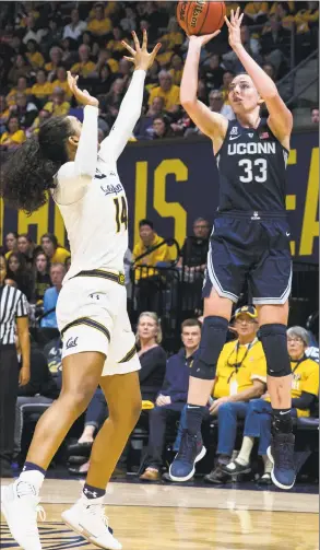  ?? John Hefti / Associated Press ?? UConn’s Katie Lou Samuelson shoots as California’s Kianna Smith defends on Saturday in Berkeley, Calif. Samuelson scored 20 points and collected 11 rebounds in the Huskies’ 76-66 win.