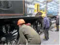  ?? JOHN SAGAR ?? A picture almost worthy of a caption competitio­n! Volunteers at haworth shed watch closely as the frames of Lancashire &amp; Yorkshire Railway 0‑6‑0 No. 957 are lowered back onto the driving wheels on December 12.