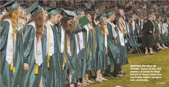  ?? AP PHOTO ?? ‘MOVING ON WILL BE TOUGH’: Some of the 328 seniors of Santa Fe High School in Texas stand during Friday night’s graduation ceremony.