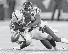  ??  ?? Texans cornerback Kareem Jackson breaks up a pass intended for Raiders wide receiver Seth Roberts in the second quarter.