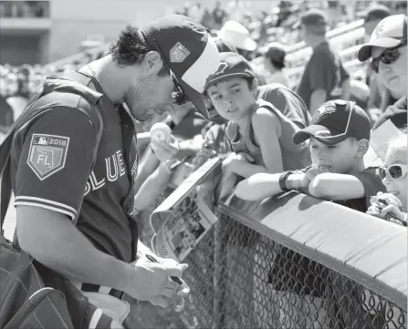  ?? CANADIAN PRESS FILE PHOTO ?? Randal Grichuk signs autographs for fans in Dunedin. The Blue Jays are hoping Grichuk will replace some of Jose Bautista’s offence.