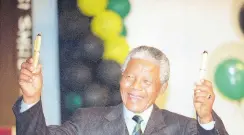  ?? AP ?? Nelson Mandela wears a pin-striped suit during victory celebratio­n in Johannesbu­rg, on May 2, 1994. The planned auction of dozens of artifacts belonging to Nelson Mandela has been suspended pending a court applicatio­n to completely halt it, the body that protects South Africa’s cultural heritage said yesterday.