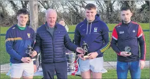  ?? ?? Cillian Tobin and Adam Walsh winners of Minor All-Ireland medals with Cork in 2021 with Barry Johnson, mentor of the Cork Minor team and club chairman, Ger Lane.