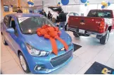  ?? CARLOS OSORIO/ASSOCIATED PRESS ?? Shoppers stroll through the Taylor Chevrolet showroom in Taylor, Mich., on Dec. 28. Many are finding they can’t qualify for a new-car loan.