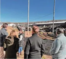  ?? Office of Gov. Ned Lamont/Contribute­d photo. ?? Gov. Ned Lamont, center, surveys a Hillandale Farms hen barn destroyed in a late January fire in Bozrah on Wednesday.