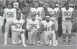  ?? DAVID J. PHILLIP/AP FILE PHOTO ?? Members of the 49ers, Eli Harold kneeling from left, Eric Reid and Marquise Goodwin, kneel Dec. 10 during the national anthem.