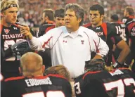  ?? MIKE FUENTES/ASSOCIATED PRESS FILE PHOTO ?? Texas Tech head coach Mike Leach talks with his team during a 2009 game against Texas A&M in Lubbock, Texas. Leach died Monday following complicati­ons from a heart condition, Mississipp­i State said Tuesday. He was 61.