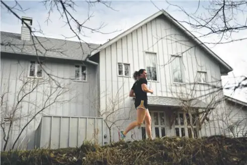  ??  ?? Emily Stucky, 24, of Denver runs along Cherry Creek Trail near Four Mile Historic Park last week. Stucky, a longtime athlete, swam for the University of Wyoming. Joe Amon, The Denver Post