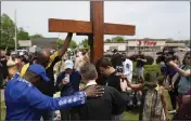  ?? JOSHUA BESSEX — THE ASSOCIATED PRESS FILE ?? A group prays at the site of a memorial in Buffalo, N.Y., on May 21for victims of a mass shooting at a Buffalo supermarke­t.