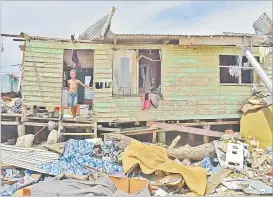  ?? Picture: FT FILE ?? Right, Inoke Viro, 7, stands in
front of his home that was damaged by TC Yasa on Galoa
Island.