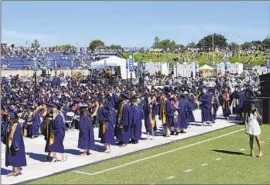 ?? Caleb Hampton Davis Enterprise ?? UC DAVIS graduates and their families faced 88- to 90-degree temperatur­es at their June 10 commenceme­nt, which ended early as dozens of people became ill.