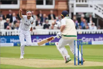  ?? (AFP) ?? England’s Stuart Broad (L) celebrates after taking the wicket of Ireland’s Paul Stirling on the opening day of their four-day Test at the Lord’s cricket ground in London on Thursday.