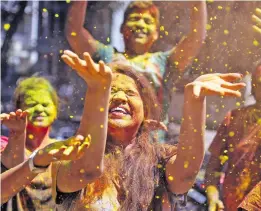  ??  ?? People in India celebratin­g Holi.