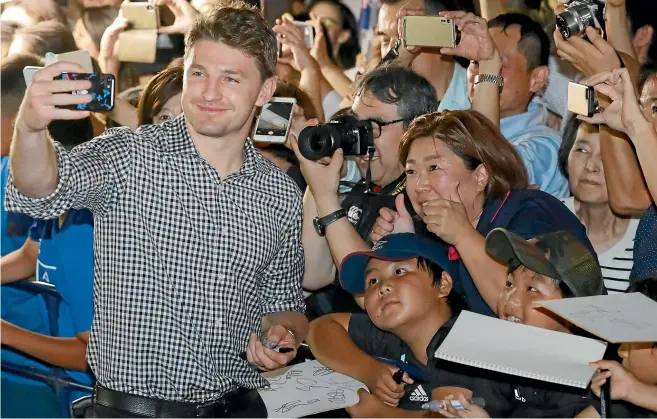  ?? AP ?? All Blacks star Beauden Barrett takes a selfie with fans at the team’s training camp in Kashiwa, Japan – ahead of their opening Rugby World Cup match tonight.