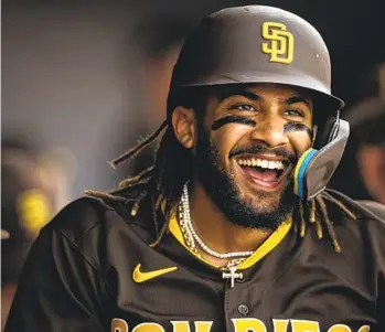  ?? MATT THOMAS GETTY IMAGES ?? Fernando Tatis Jr. celebrates in the dugout after scoring Saturday in a game he got his first hits of the spring.