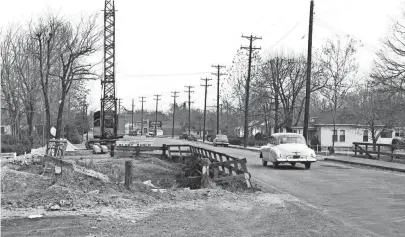  ?? THE COMMERCIAL APPEAL FILES ?? City Engineerin­g Department crews conduct pile boring tests on 8 Dec 1954, preliminar­y to widening a bridge in the 3300 block of Broad in order to convert the street into a through street from East Parkway to Summer at National. Improvemen­t is expected to divert a large volume of traffic from Summer west of National. The expanded part of the bridge will be of steel and concrete constructi­on.