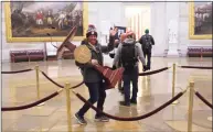  ?? Win McNamee/Getty Images / TNS ?? Adam Johnson, 36, of Parrish, Fla., faces felony charges after he was seen carrying House Speaker House Nancy Pelosi’s lectern through the U.S. Capitol on Jan. 6.