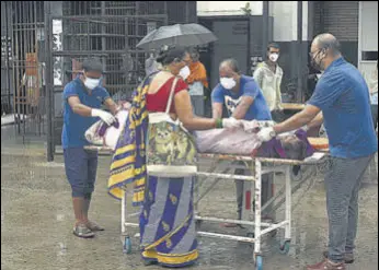  ?? HT FILE PHOTO ?? Family members of a Covid patient shift him to another hospital without wearing proper gear due to lack of attention at National Medical College and Hospital in Patna last year.