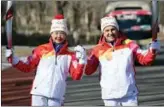  ?? LI HE / XINHUA ?? Juan Antonio Samaranch Salisachs, IOC vice president and chairman of the Coordinati­on Committee for Beijing 2022, joins Chinese IOC member Li Lingwei in the torch relay at Beijing Olympic Park on Feb 4.