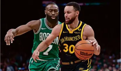  ?? DANIELLE PARHIZKARA­N/GLOBE STAFF ?? Not only did Jaylen Brown pace the Celtics’ victory with 29 points, 19 in the first quarter alone, he helped harass the Warriors’ Stephen Curry into a 4-point game (2-for-13 shooting).