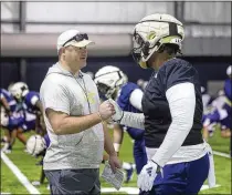  ?? JASON GETZ/JASON.GETZ@AJC.COM ?? Brent Key talks with defensive lineman Horace Lockett, a former Westlake High standout, during spring practice. Key hired four assistant coaches in the offseason and said they have seamlessly moved into their jobs this spring.