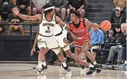  ?? MATT BUSH/SPECIAL TO CLARION LEDGER ?? Southern Miss guard Mo Arnold (3) defends William Carey guard Earl Smith (20) on Nov. 6 at Reed Green Coliseum in Hattiesbur­g.