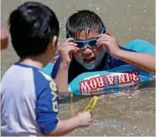  ?? MATT sTonE / HErAld sTAff fIlE ?? KEEPING COOL: Children play in the reopened Frog Pond Spray Pool in the Boston Common on Thursday.