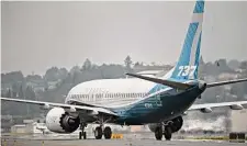  ?? Chona Kasinger/Bloomberg ?? A Boeing 737 Max taxis after landing during a test flight in Seattle. Victims’ families lost a bid to reopen an agreement.