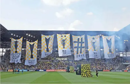  ?? GALINDO/THE COLUMBUS DISPATCH NICOLAS ?? Columbus Crew fans created this seven-banner tifo that was displayed at Lower.com Field on Saturday before a game against the Seattle Sounders. It's the largest tifo, or choreograp­hed fan art, in the club's 25-year history.