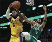  ?? MICHAEL DWYER — THE ASSOCIATED PRESS ?? The Lakers’ LeBron James (6) and Boston Celtics’ Jayson Tatum (0) battle for a rebound during the first half on Friday in Boston.