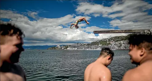  ?? PHOTO: ROBERT KITCHIN/FAIRFAX NZ ?? Seventeen-year-old Bailey Van de Coolwijk, of Wellington, backflips into the harbour, making the most of yesterday’s hot weather.