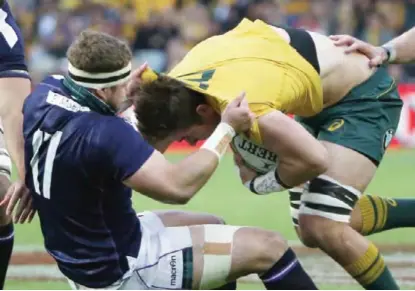  ?? —AP ?? SYDNEY: Australia’s Richard Hardwick, right, is pulled over by Scotland’s Allan Dell during their rugby union test match in Sydney, Saturday.