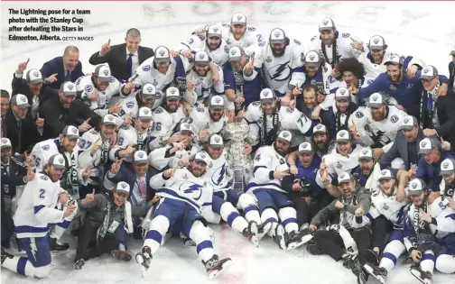  ?? GETTY IMAGES ?? The Lightning pose for a team photo with the Stanley Cup after defeating the Stars in Edmonton, Alberta.